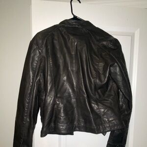 Used. Guess leather jacket. Size Medium. Some wear around collar.